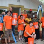 Group photo with Home Depot volunteers, homeowner, family, and Habitat staff